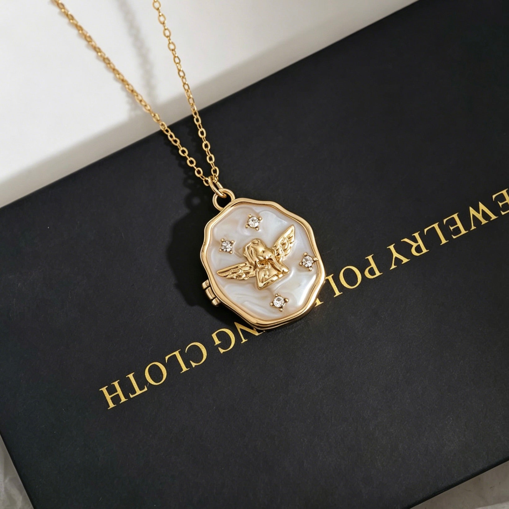 Gold necklace with a pendant on a black box labeled 'Everyday Jewellery'.
