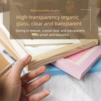 Hand holding a transparent glass panel over books with promotional text about high-transparency organic glass.