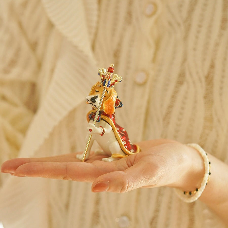 Hand holding a decorative figurine of a horse and rider on a beige background