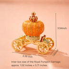 Gold and orange pumpkin carriage with decorative elements on a pink background, showing measurements.