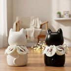 Two cat-shaped decorative items with lace details on a wooden surface.