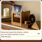Wooden pet memorial with space for photos of a cat, on a wooden surface.