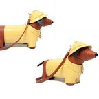 Dog-shaped handbag with a yellow raincoat and hat on a white background
