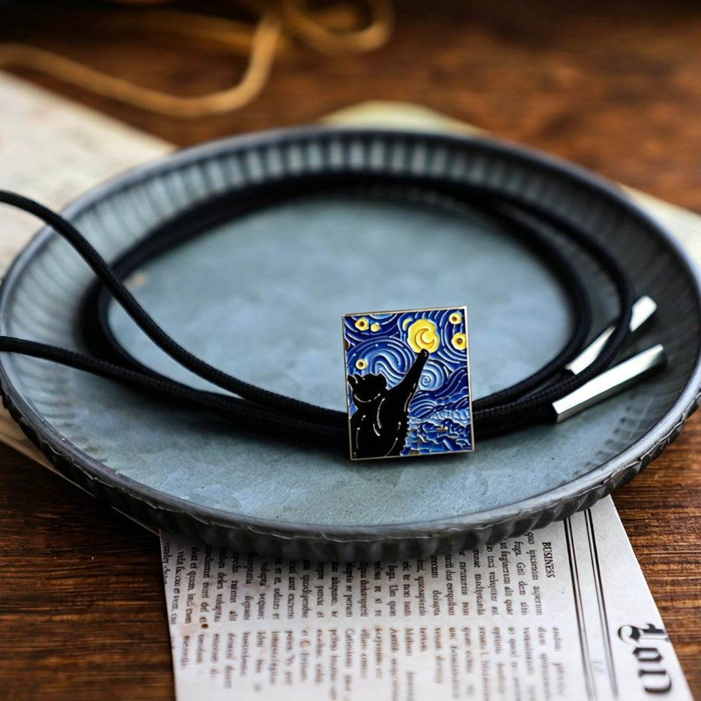Necklace with a pendant resembling 'Starry Night' on a ceramic plate.