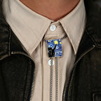 Person wearing a brooch with a black cat design on a beige shirt and dark jacket.