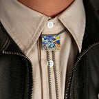 Bolo tie with artistic design worn on a beige shirt and black jacket
