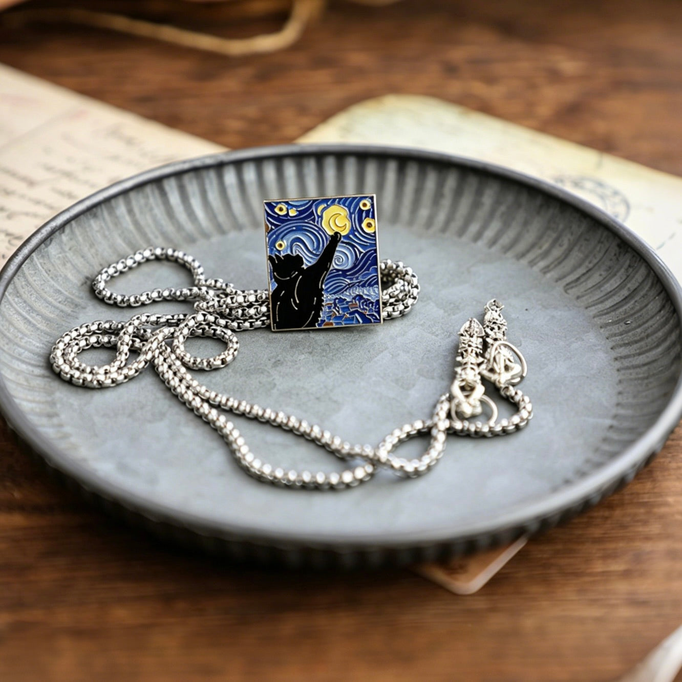 Necklace with a pendant featuring 'Starry Night' design on a textured plate.