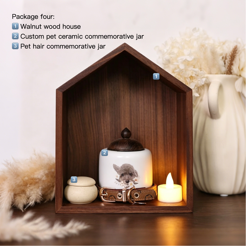 Wooden house-shaped display with pet memorials and a candle on a neutral background