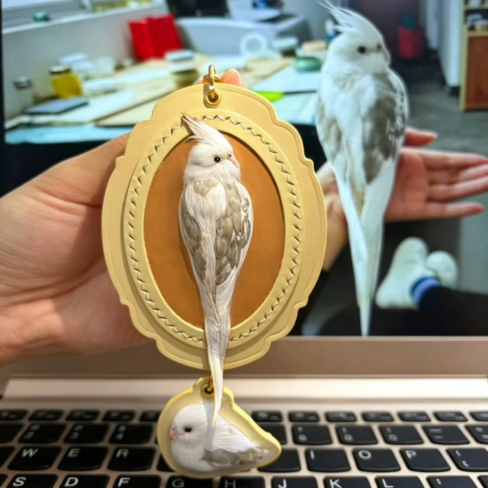 Bespoke exotic animal leather pendant keychain featuring a detailed 3D hand-carved African Grey parrot relief design