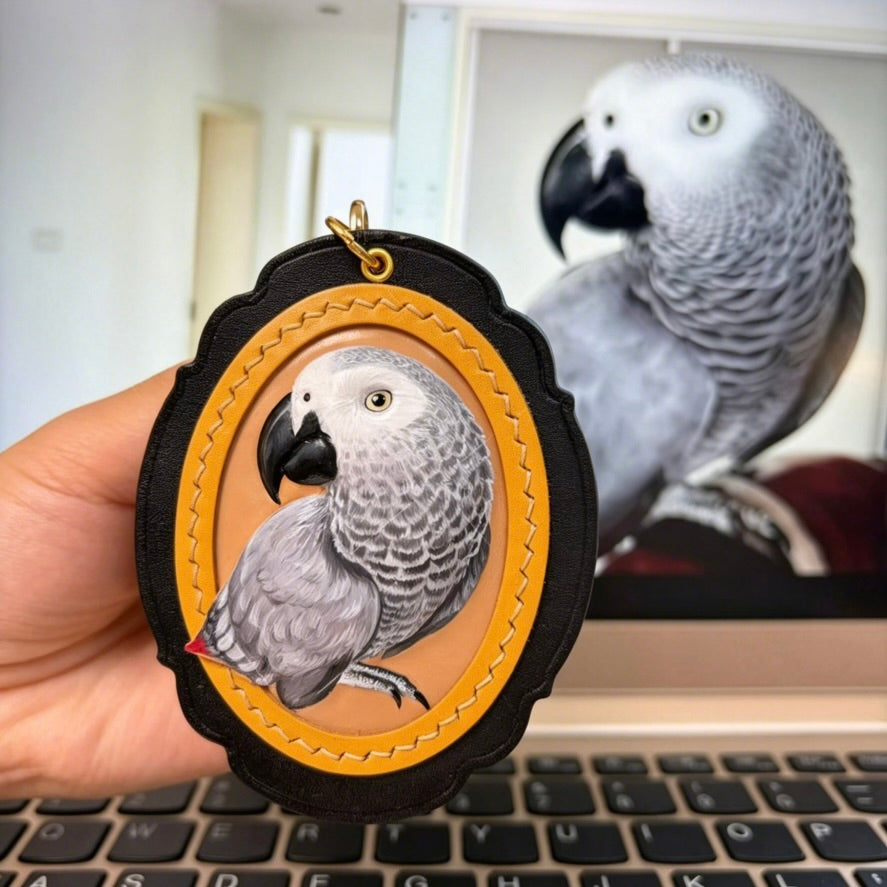 Bespoke exotic animal leather pendant keychain featuring a detailed 3D hand-carved African Grey parrot relief design