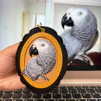 Bespoke exotic animal leather pendant keychain featuring a detailed 3D hand-carved African Grey parrot relief design