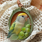 Bespoke exotic animal leather pendant keychain featuring a detailed 3D hand-carved green parrot and grapes relief design