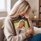 Woman wearing an animal portrait bracelet while holding a framed photograph of her cat