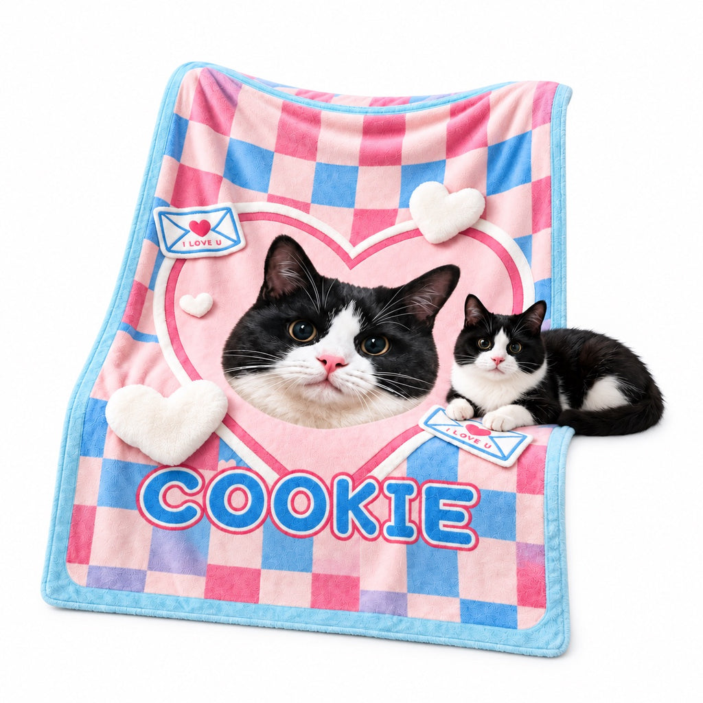 Pink and blue checked flannel blanket with a tuxedo cat portrait and the name Cookie, displayed beside a cat