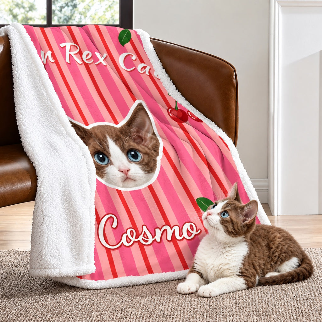 Pink Cosmo cat portrait sherpa blanket draped over a chair with its white fleece reverse visible