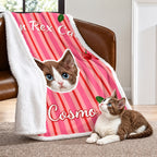 Pink Cosmo cat portrait sherpa blanket draped over a chair with its white fleece reverse visible
