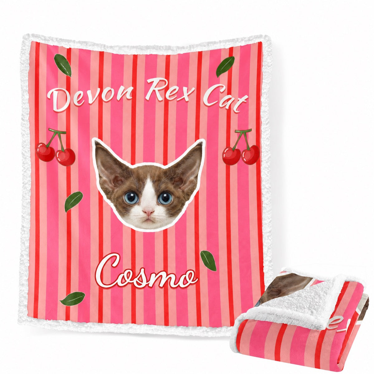 Pink striped sherpa blanket with cherries, a cat portrait and the name Cosmo, shown open and folded