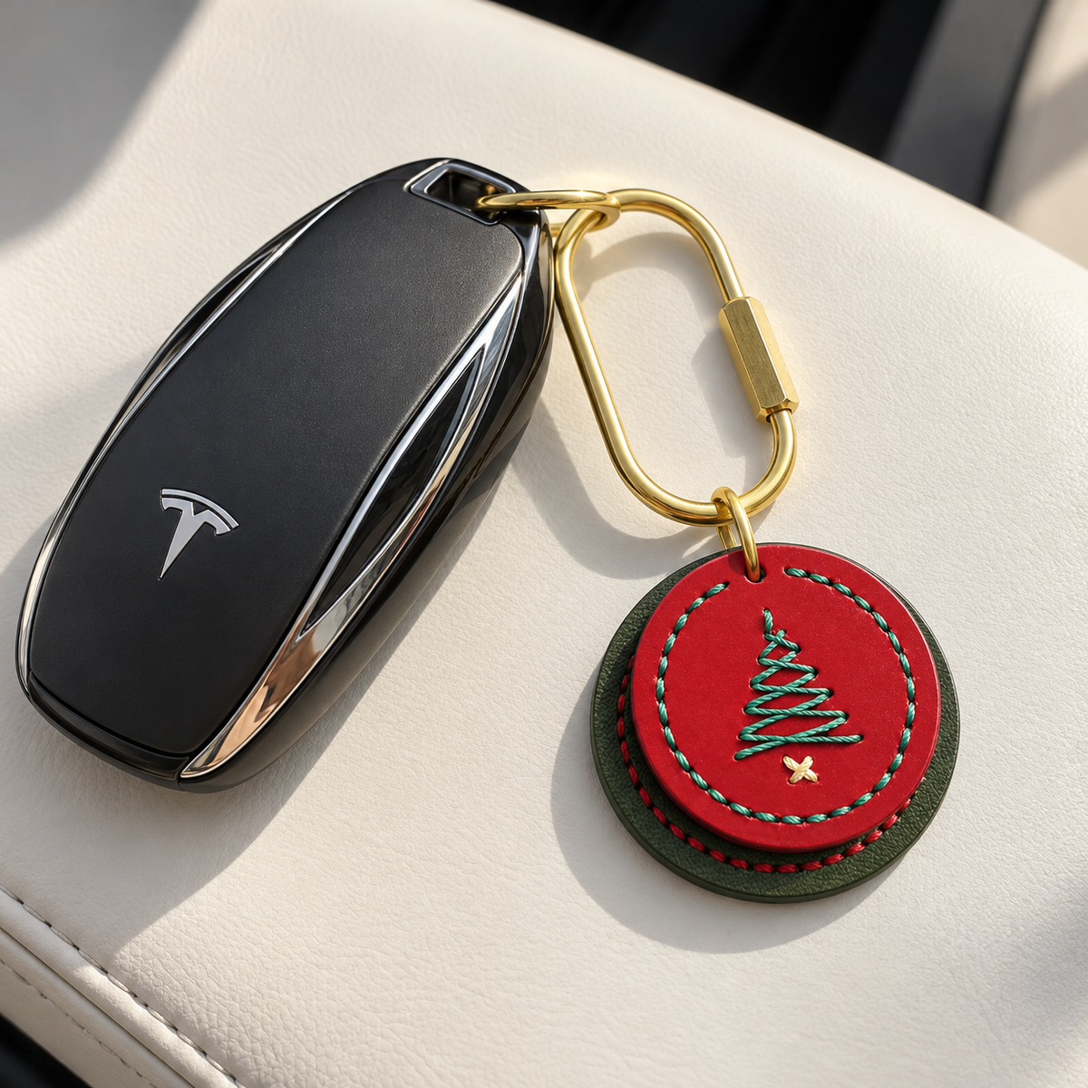 Red and green stitched cowhide Christmas tree charm attached to a car key with a brass clasp