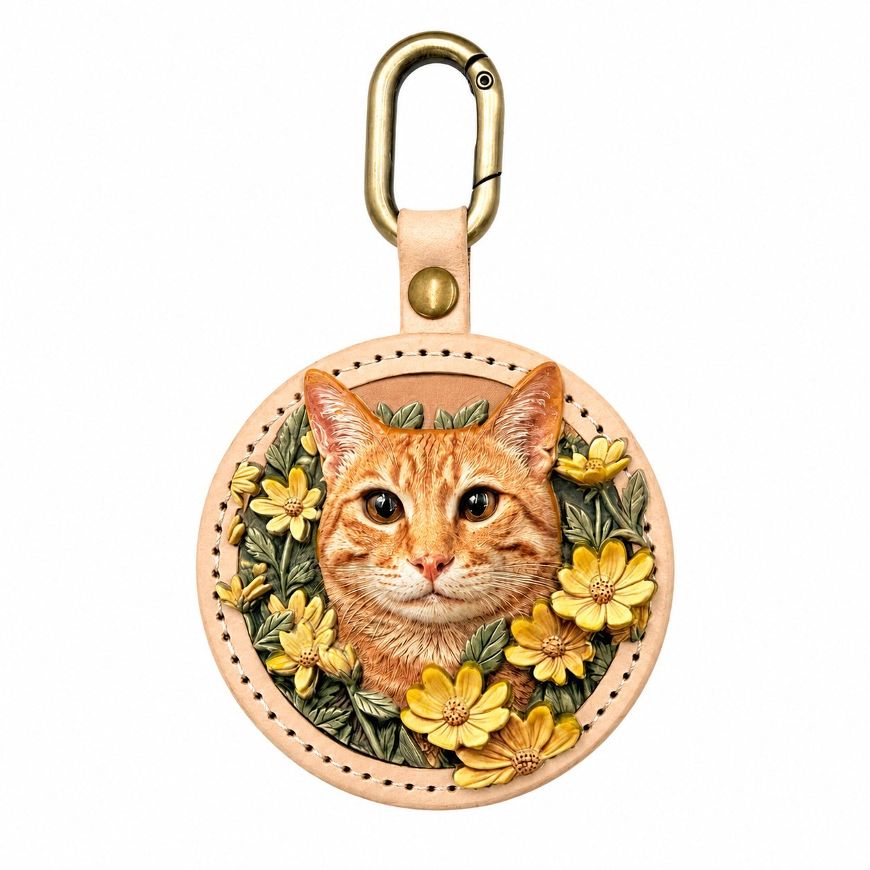 A round stitched leather keychain featuring a custom 3D relief portrait of an orange tabby cat, intricately hand-painted and framed by yellow flowers. Attached to a gold metal clasp, this personalized pet charm by Memopaw serves as a unique handmade pet memorial gift.