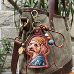 A custom illustrated brown dog portrait leather bag charm wearing a brown beanie hat and a blue striped shirt, styled as a personalized pet photo keychain hanging on a canvas tote bag.