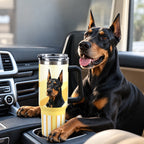 Doberman sitting beside a yellow custom dog photo tumbler in a car interior