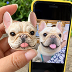 Custom French Bulldog 3D pet portrait pendant held beside the reference photo on a phone