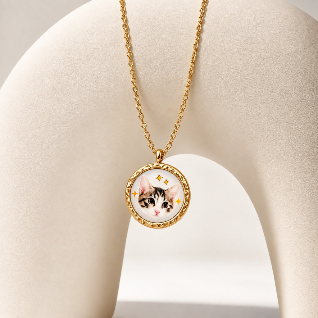 Round mother-of-pearl pet portrait necklace with custom tabby cat photo and star accents on gold chain