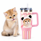Orange kitten beside a pink handled custom tumbler printed with a cat portrait and striped pink design