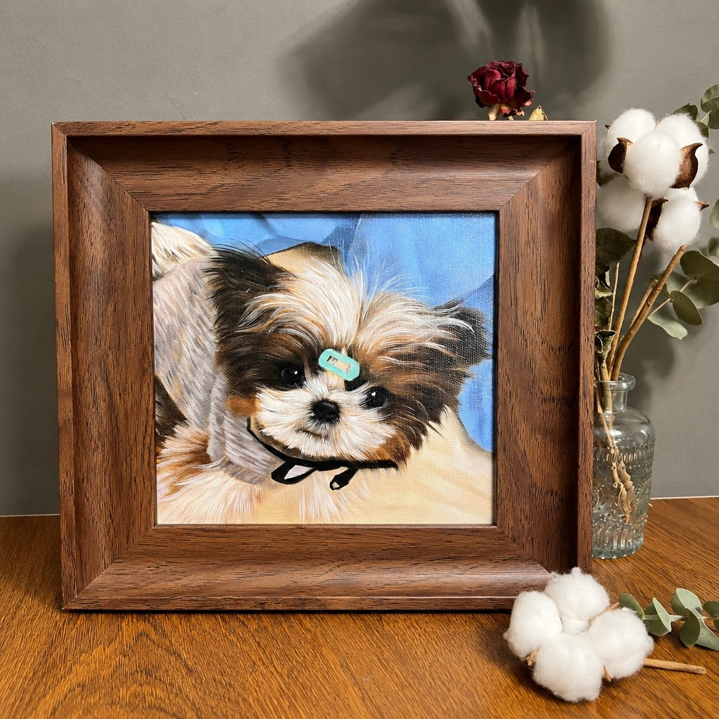 Custom hand-painted oil painting portrait of a small dog in a dark wooden frame, displayed next to dried cotton flowers and a glass vase on a tabletop.