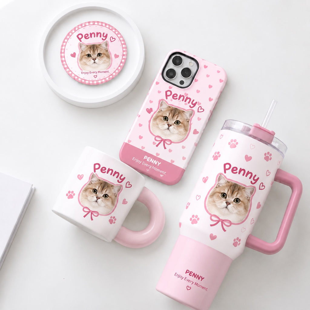 Custom pet portrait gift set in pink checkered pattern featuring personalized cat photo mug, tumbler, phone case, and pin badge next to a white cat.