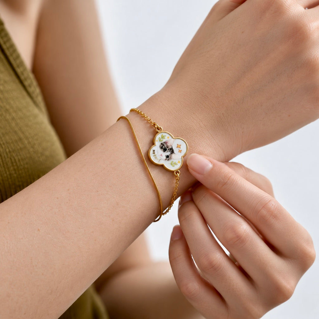 A model wearing a custom pet portrait mother-of-pearl clover bracelet in 18K gold.