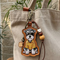 A custom illustrated Schnauzer dog portrait leather bag charm wearing sunglasses and a yellow striped shirt, styled as a personalized pet photo keychain with decorative beads.