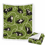 Green custom sherpa blanket featuring a repeating black and white tuxedo cat pattern with white swirl lines and fleece reverse