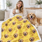 Person facing the camera with a yellow repeating dog portrait sherpa blanket and a golden dog on the sofa