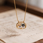 Gold-tone double pet portrait necklace displayed over a handwritten letter