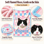 Cookie cat blanket detail graphic showing fleece texture, blue edging, envelope motifs and the printed portrait
