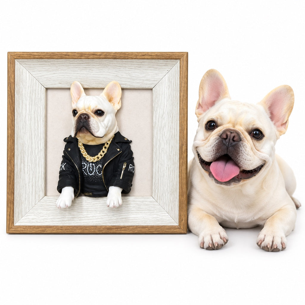 Cream French bulldog beside a framed 3D half-body dog portrait wearing a black jacket and gold-colored chain