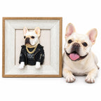 Cream French bulldog beside a framed 3D half-body dog portrait wearing a black jacket and gold-colored chain