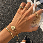 Gold single-chain pet hair memorial bracelet with an engraved cat portrait worn on a wrist
