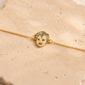 Gold-tone personalized bracelet with a custom child portrait line-art charm