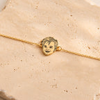 Gold-tone personalized bracelet with a custom child portrait line-art charm