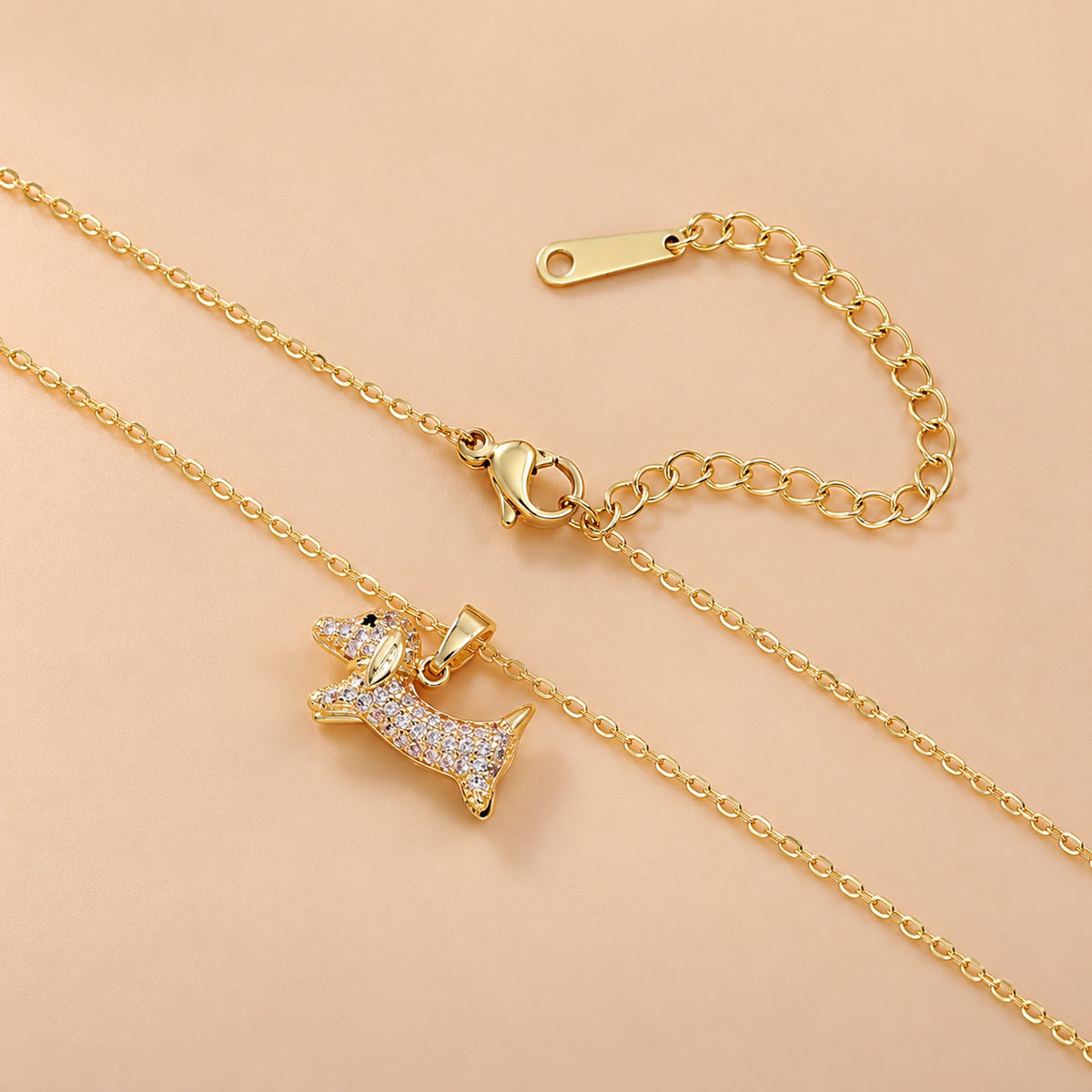 Gold-tone dachshund pendant necklace with chain, lobster clasp and extender detail