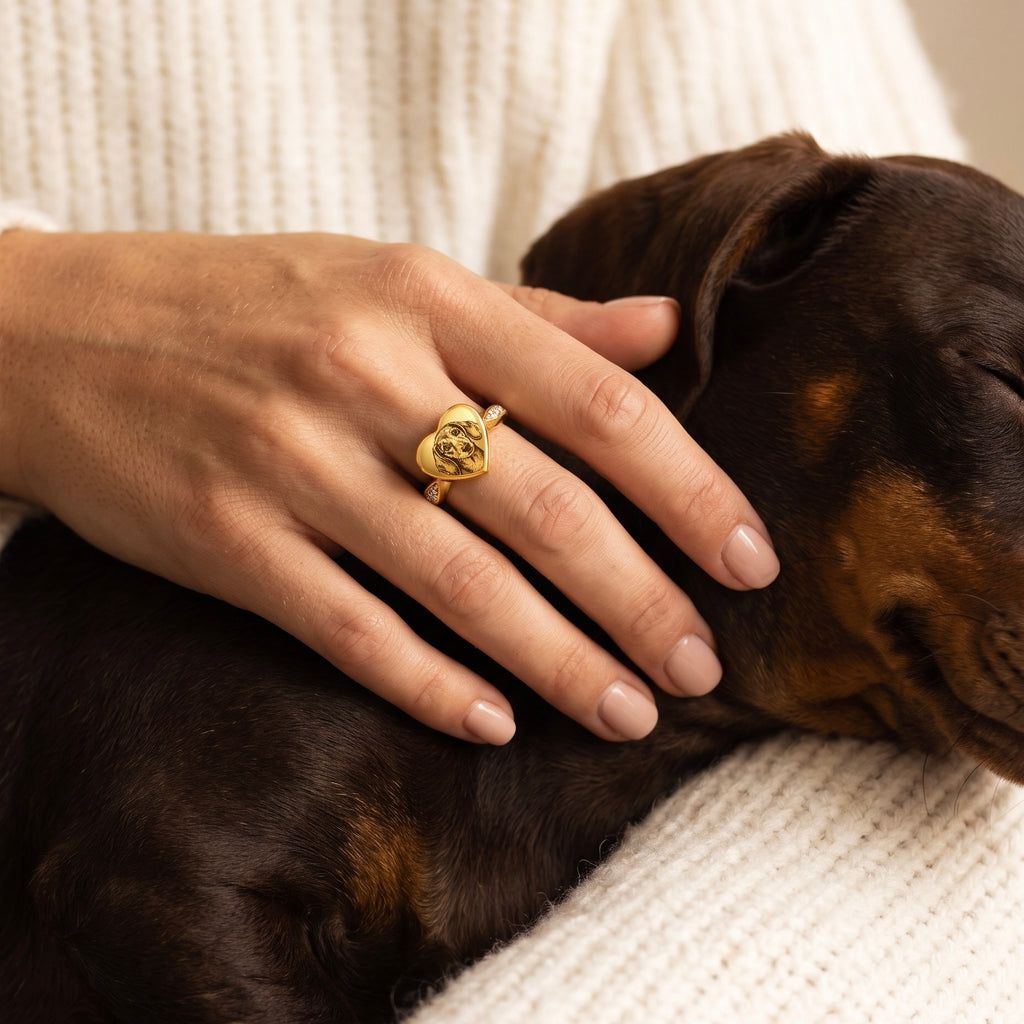 Gold heart pet ashes ring personalized with a Dachshund portrait and worn beside the dog
