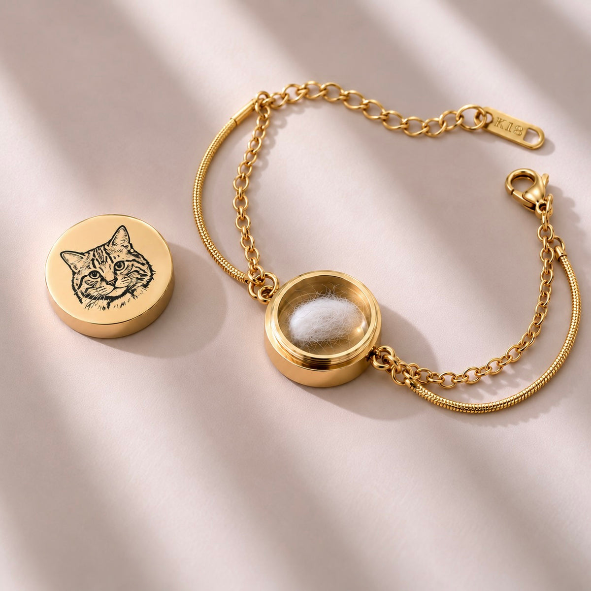 Open gold double-chain pet bracelet showing the small interior compartment with a fur clipping
