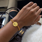 Gold-tone personalized pet portrait bracelet worn on the wrist