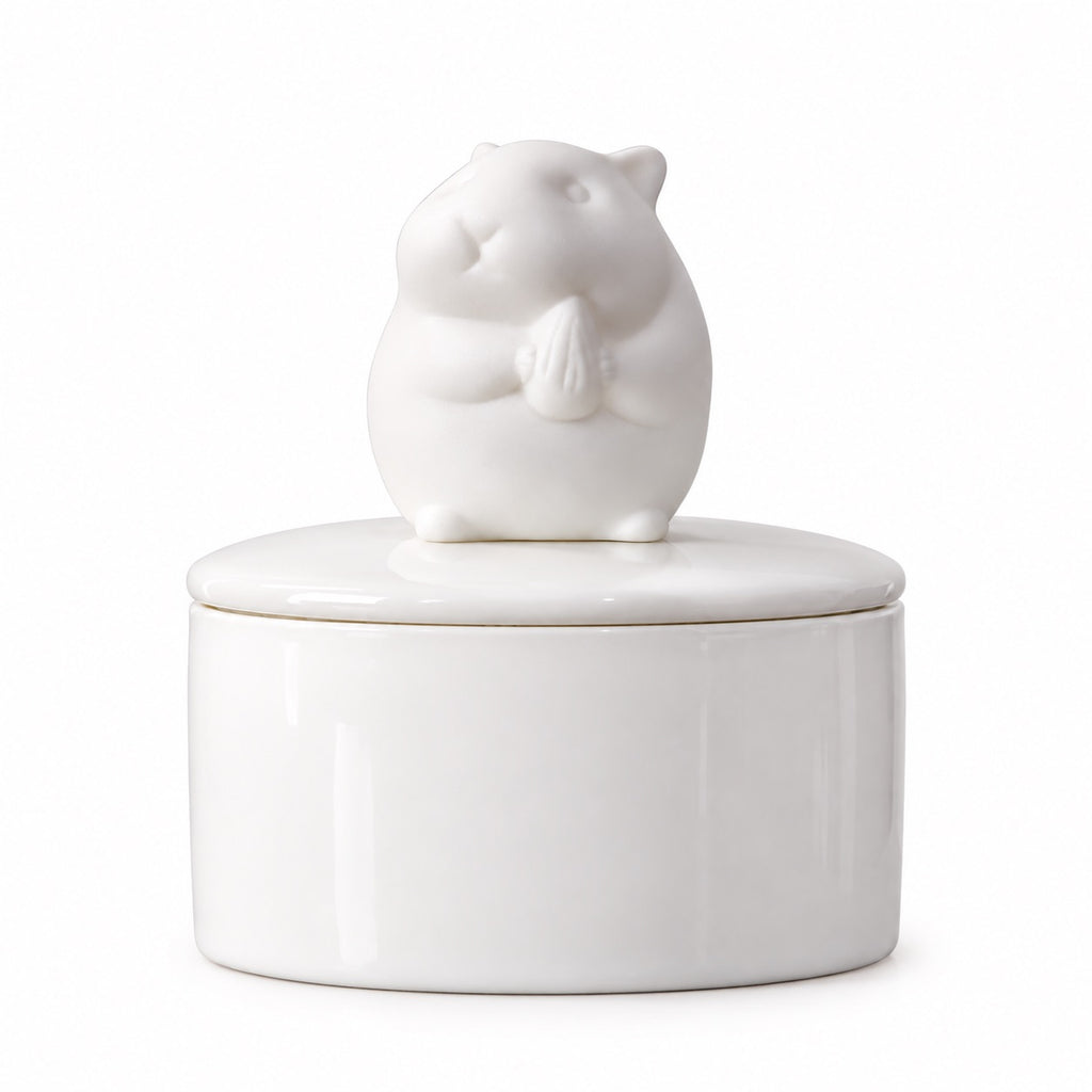 White ceramic hamster memorial urn with an upward-looking hamster figure on the lid