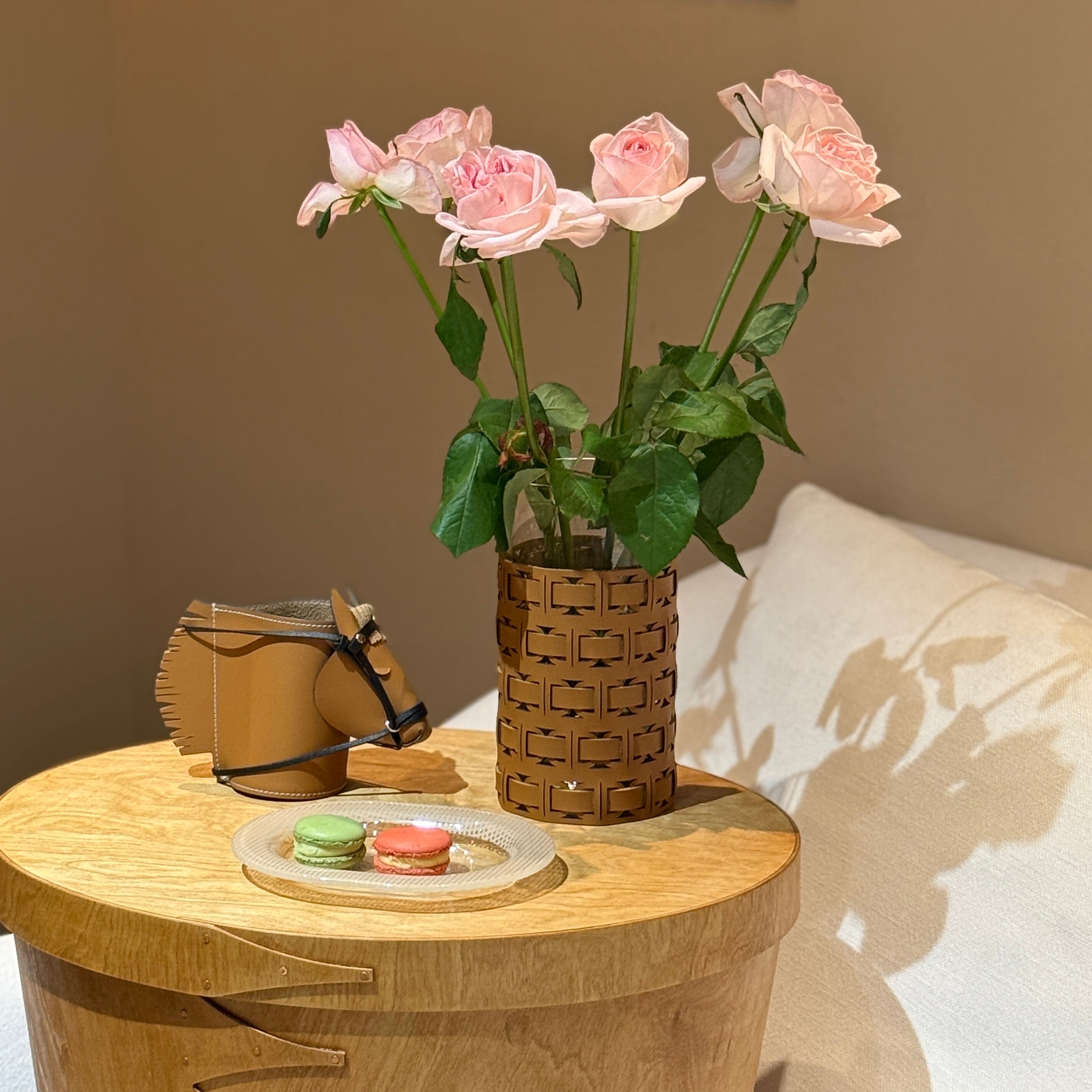 A luxury leather horse desk organizer and pen holder displayed on a wooden table next to a vase of pink roses, showcasing premium equestrian theme office desk accessories.