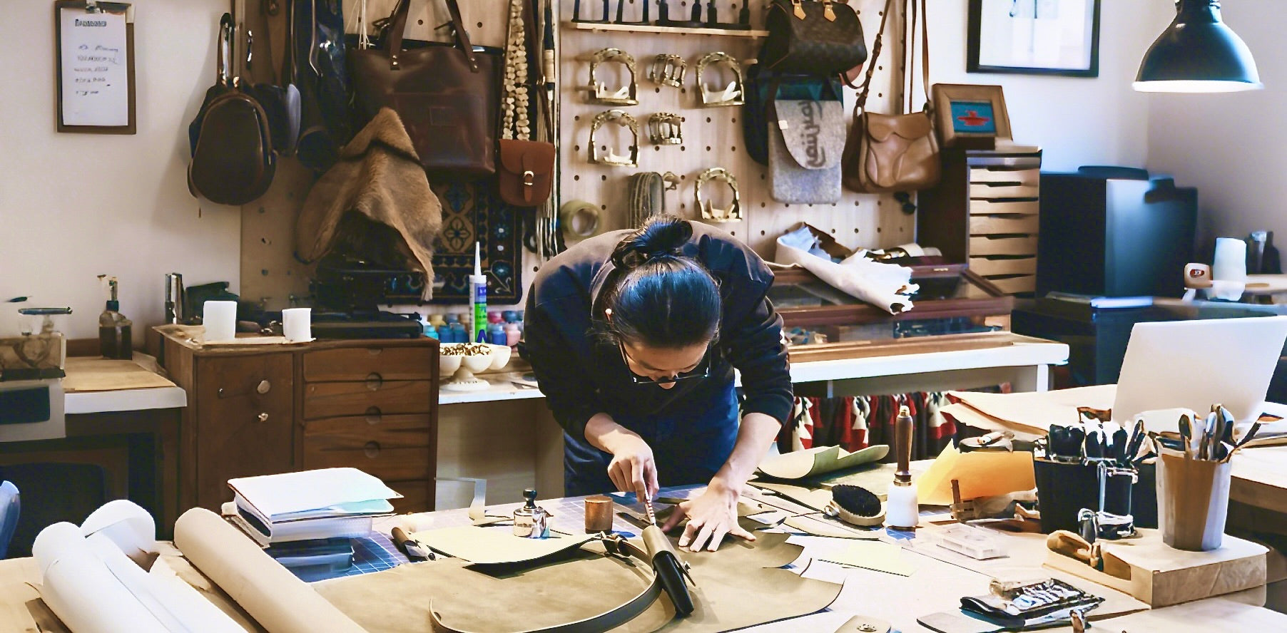 A master artisan meticulously carving and shaping raw leather fibers by hand in a workshop to create a custom 3D pet portrait.