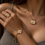 Model wearing coordinated gold-tone pet portrait ring, double-sided necklace and clover bracelet
