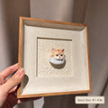 Hand holding a light-colored frame with an orange-and-white cat head portrait, labeled 4 by 4 inches inner size